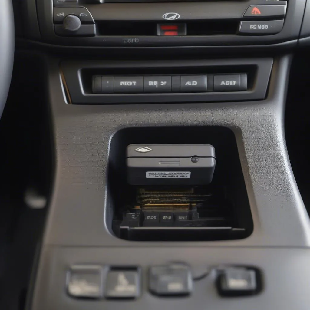 OBD2 port under the dashboard of a car