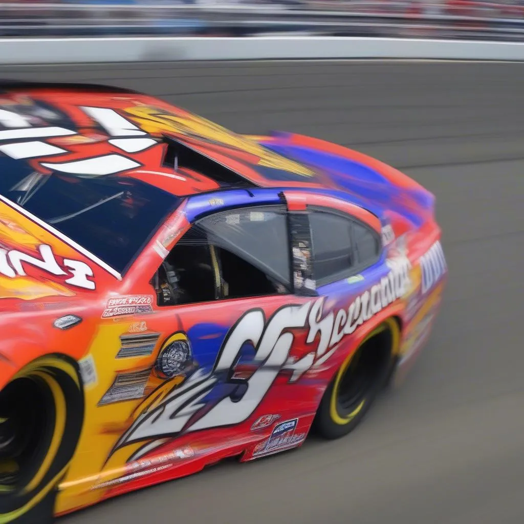 Close-up of a NASCAR race car, focusing on the sponsor logos and the driver's name