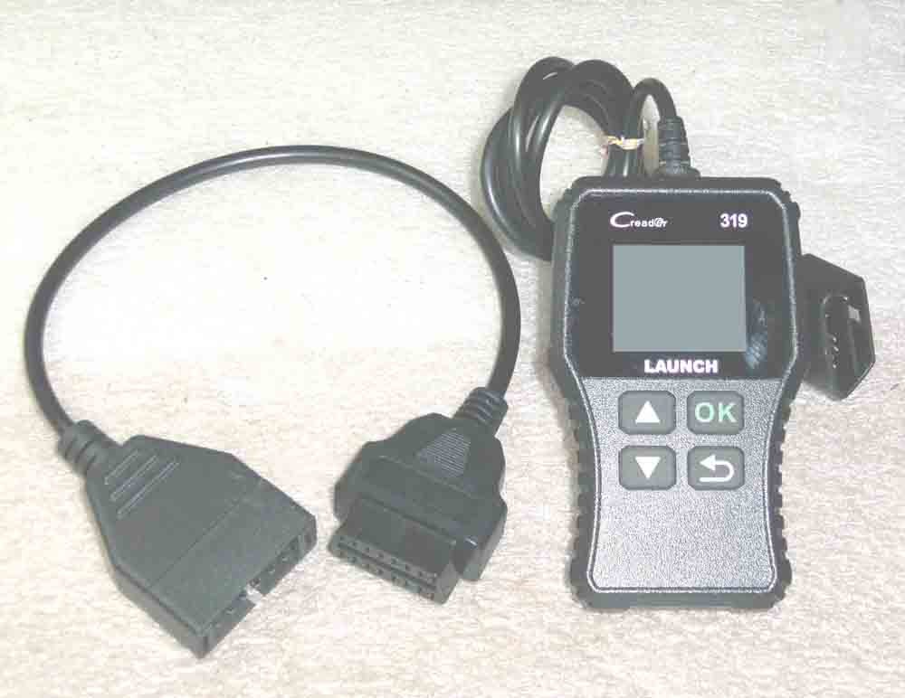 Close-up of an ALDL to OBD2 adapter, highlighting its connectors.