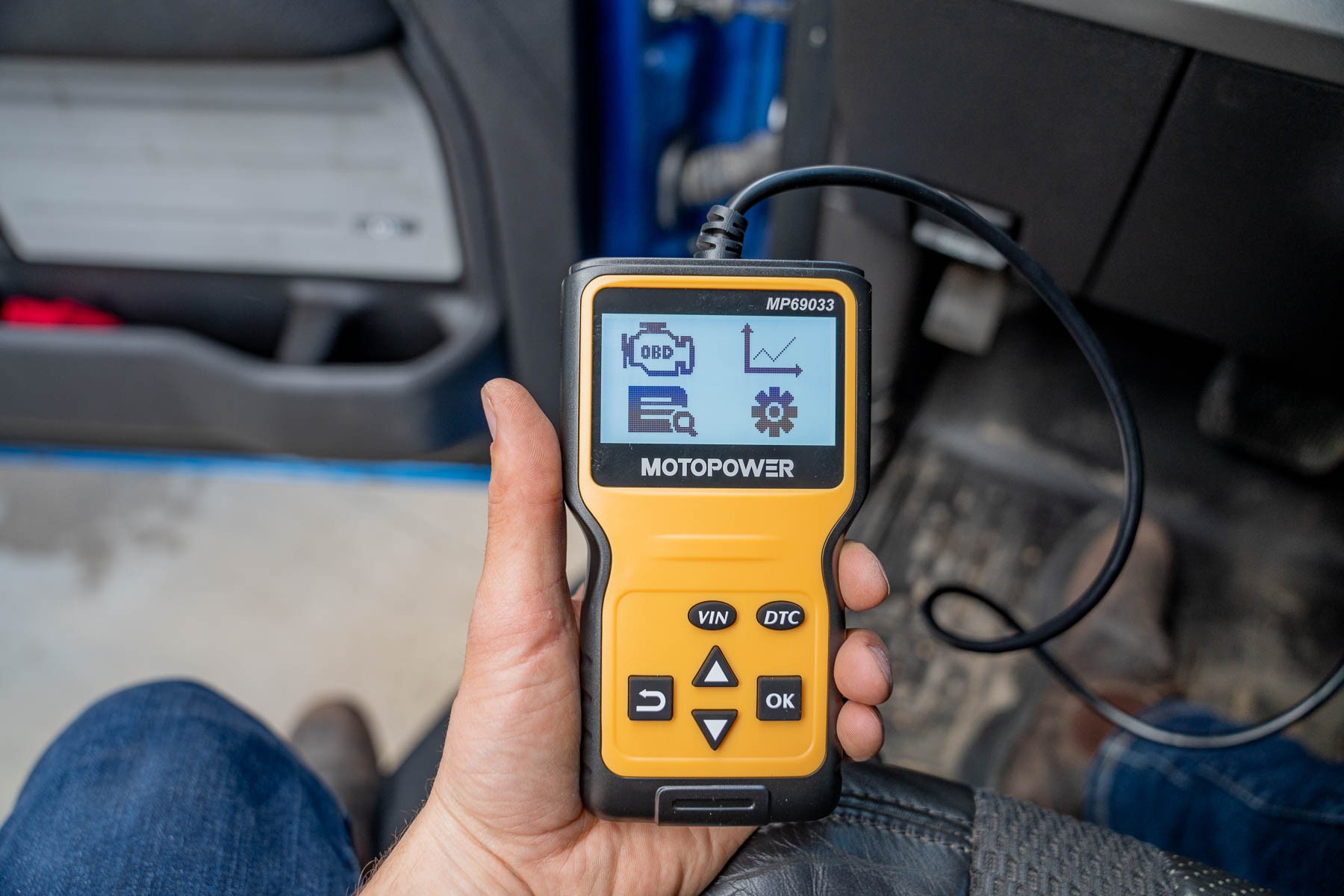 User holding an OBD2 scanner