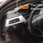 OBD2 port location under the dashboard of a car