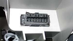 A close-up view of a standard OBD-II port in a vehicle, ready for adapter insertion.