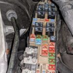 Fuse box of a 2009 Ford Hybrid Escape showing missing fuses, a potential issue for OBD2 system and starting problems.